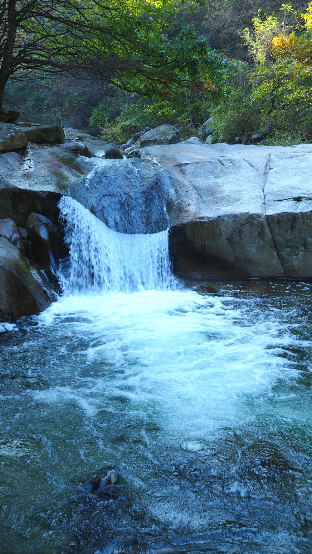 Seoam Rock Waterfall in Jirisan is a beautiful cascade with many names. One of its names describes a Buddhist monk that seems to be reading the Buddhist scripture.